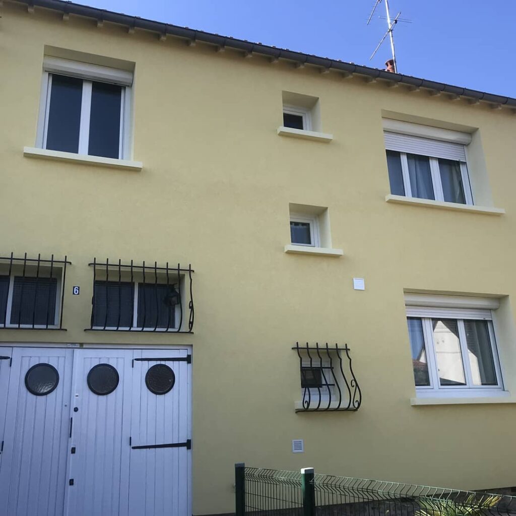 Façade jaune de bâtiment avec fenêtres et portes rénovées; Advalidem; Rénovation énergétique.