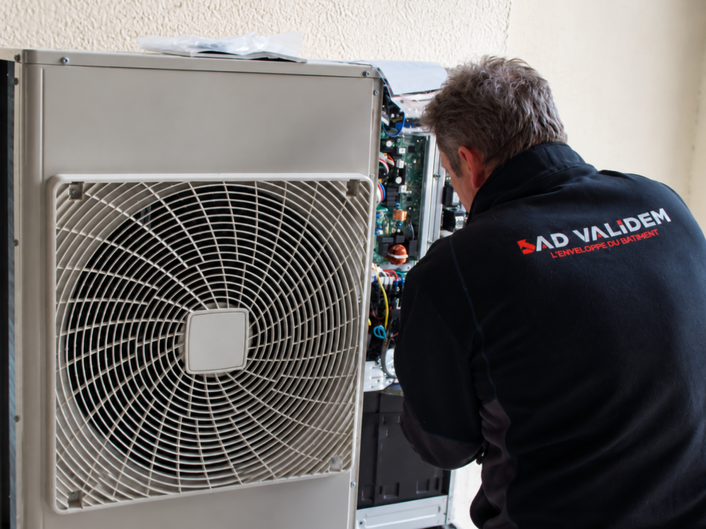 Technicien AD VALIDEM effectuant une rénovation énergétique sur un équipement.
